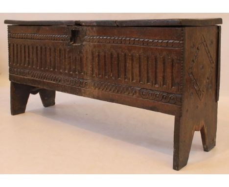 A late 17th Century oak six plank coffer
The hinged lid above chisel and guilloche carved front panel, flanked by lozenge car