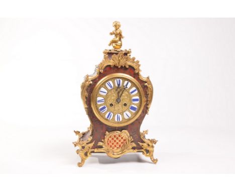 A French Louis XV style boulle mantel clock
With a 14cm brass dial with blue and white enamel cartouches with Roman numerals 