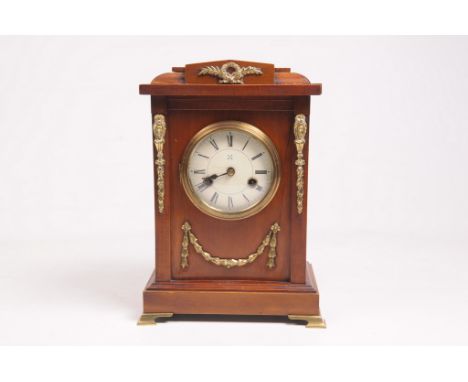 A stained walnut and brass embellished mantel clock
With a 10cm convex dial the two train Hamburg American Clock Company move