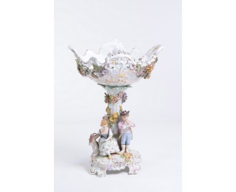 A Dresden figural two handled comport
A flower encrusted pierced oval basket resting on truncated tree applied with flowers w