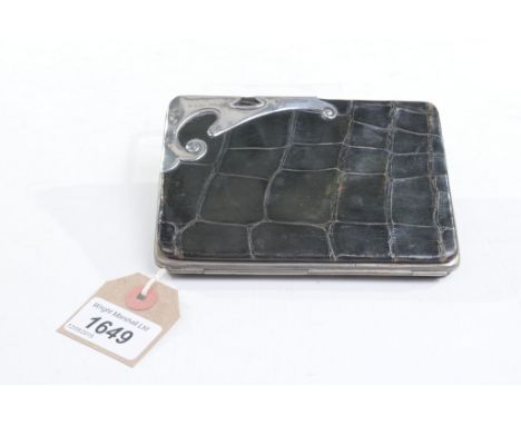 An Edward VII silver mounted crocodile ladies wallet
The dyed black crocodile purse with gothic silver mount, the button clas