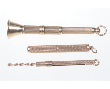 Three 9ct gold cigar piercers 
Each with engine turned decoration to the outside, hallmarked Birmingham 1951, London 1955 and