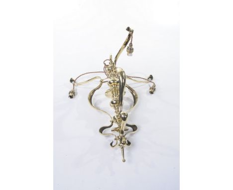 A brass light fitting
With a central mushroom knopped baluster stem with scrolling branches fitted for electricity. 57cms.