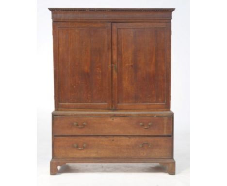 A 19th Century oak linen press
With a dentil and cavetto cornice above a fluted frieze with a pair of panelled cupboard doors