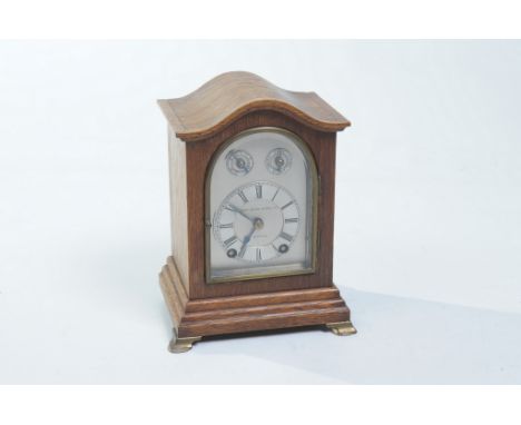 An oak cased bracket clock, late 19th early 20th Century
With a  9.5cm arched silvered dial signed John Byrne & Son Ltd., Liv