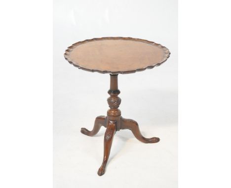 A Chippendale style mahogany tripod table 
19th Century with a 66cm diameter pie crust top raised upon a turned spirally flut