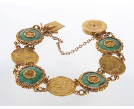 A jade plaque and coin set bracelet
Set with alternate round jade plaques and mounted gold coins to push clasp, with Chinese 