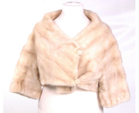 A Kendal Milne of Manchester cream mink cropped jacket, circa 1960's
Collarless with crossover design and twin button fasteni