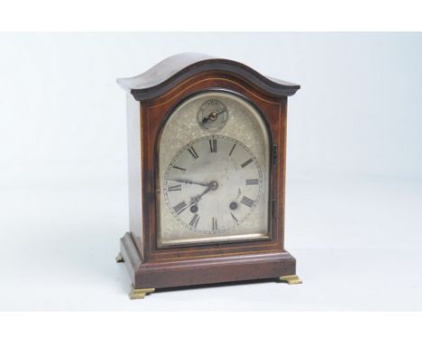 An Edwardian inlaid mahogany bracket clock
With a 14cm silvered dial, Roman numerals with a slow fast dial in the arch the tw