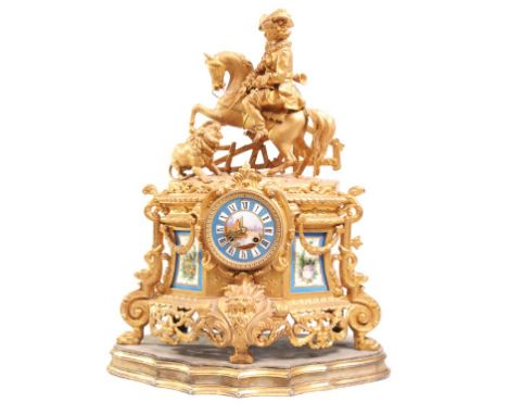 A 19th Century French gilt metal and porcelain mounted mantel clock
With a 9.5cm porcelain dial painted with a river view, Ro