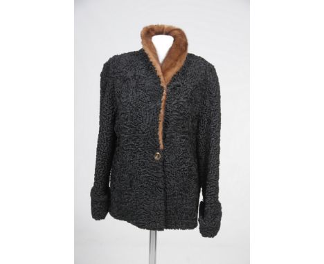 A black Persian lamb jacket, with mink collar, circa 1960's
With single button detailing to front and flared arms, chest appr