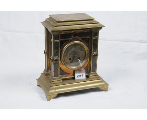 A Victorian brass variegated marble and hardstone mantel clock
With a 9cm dial with Roman numerals, the two train Japy Freres