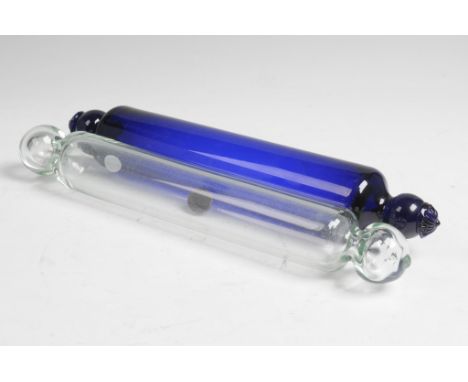 A 19th Century Nailsea style glass rolling pin
With roundel and flower head terminals. 34cms, and a clear glass rolling pin e