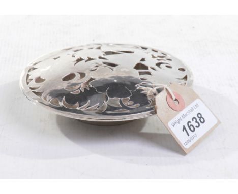 A Scottish silver pierced lidded dish
Of circular form, the cover pierced with abstract stylised designs, sitting on integrat