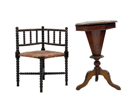 A 19th century walnut octagonal workbox With a hinged crossbanded top on a faceted tapering column raised on tripod feet, hei