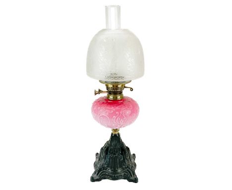 A Victorian brass oil lamp with etched glass shade.  With a moulded cranberry glass reservoir and etched glass shade, on a ca
