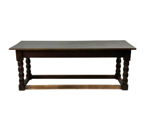 An oak refectory dining table. 20th century, raised in stout square section bobbin turned legs, united by box stretchers, hei