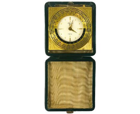 A Swiss Worldwide travel alarm clock by Luxor for Asprey. With gilt adjustable dial, in a green leather case, width 9.5cm.The
