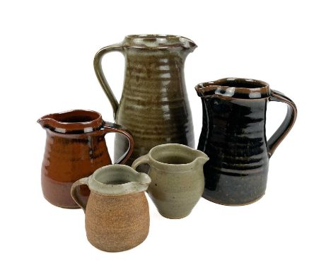 A Leach Pottery standard ware jug. Impressed marks, height 21.5cm, together with four other Leach Pottery jugs. (5)The larges