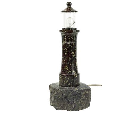 A cornish turned serpentine lighthouse table lamp. On a naturalistic base, height 30.5cm.This lamp will need to be re-wired, 