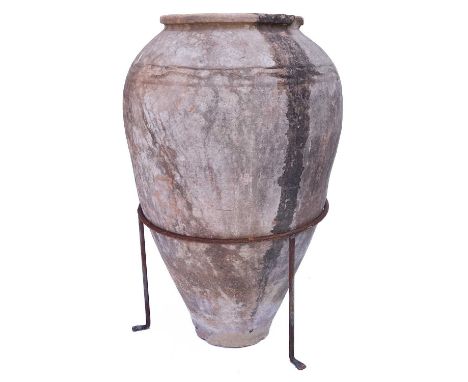 A terracotta olive jar. With a wire tripod stand, overall height 69cm.