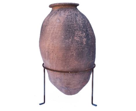 A terracotta olive jar. With a wire tripod stand, overall height 72cm.