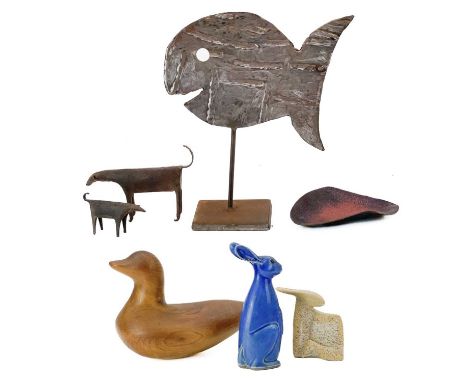 A yew carved duck decoy. Height 20cm, together with two ironwork model cows, steel fish, studio pottery hares and an enamel d