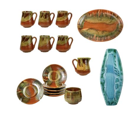 A collection of Lamorna pottery.  To include six cups with saucers, a milk jug, a small cup, a platter, and another similar p
