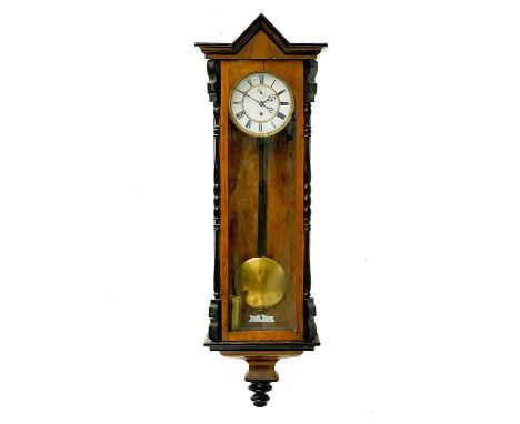 A Vienna regulator type walnut wall clock. Late 19th century, with ebonised mouldings and architectural cornice, circular whi