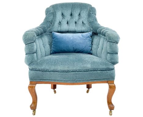 A late Victorian walnut framed button back tub chair. Raised on cabriole legs with brass castors, height 82cm, width 71cm, de