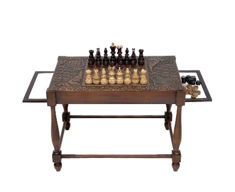 A Cornwall theme chess table. With twin slide out mirrored leaves on turned supports and chamfered stretchers,height 50cm wid