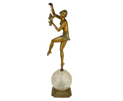 A French Art Deco table lamp. With a bronzed spelter female dancer holding a marionette of Pierrot standing on a faceted glas