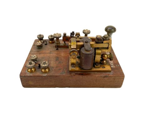A brass G.P.O telegraph Key serial number 6787. Mounted on mahogany with Broad Arrow and Basebords. S.C.MK I, length 22.5cm.