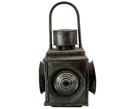 A late 19th century tinned railway level crossing lamp. Fitted two red and two clear glass lenses, with fixed handle, height 