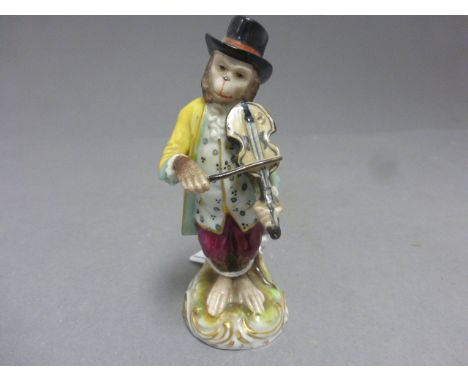 A continental ceramic figure of a monkey playing a violin, with blue crown mark to the base