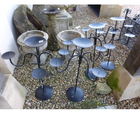 Four black metal candlestick holders