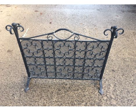 Wrought iron fireguard with scrolling decoration