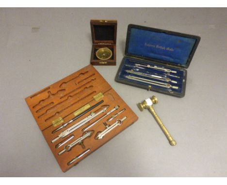 A cased Halden's drawing set, along with one other, a compass and a gavel 