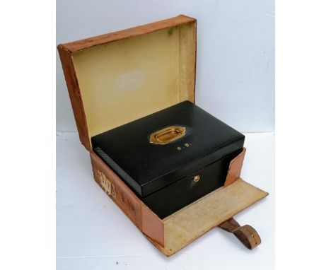 An Edwardian vanity case with two-tier interior, Bramah lock and outer calfskin trunk,&nbsp; inner dimensions 16.5 x 36 x 26 