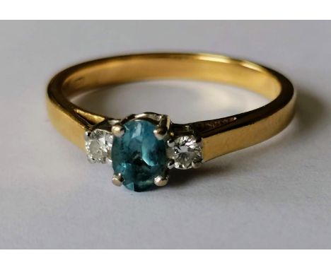 An 18ct yellow gold diamond and aquamarine ring, the oval-cut aquamarine approx. 0.32 carats, flanked with two small diamonds