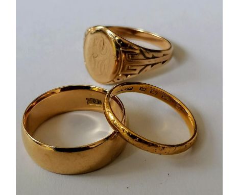 An 18k wedding band, 5mm, stamped, size M, 5.34g a wedding band, size I, hallmarked and a signet ring, size K, 1.98, not hall