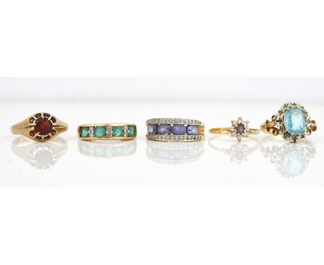 FIVE 9CT GOLD AND GEM SET RINGS (5)Comprising; a blue topaz and diamond oval cluster ring, ring size O, a garnet single stone