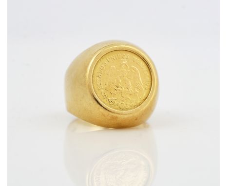 A GOLD RING MOUNTED WITH A MEXICO DOS PESOS 1945The ring detailed 750, ring size I and a half, weight 5.8 gms