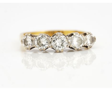 A GOLD AND DIAMOND FIVE STONE RINGClaw set with a row of graduated circular cut diamonds, detailed 18 CT, ring size R, gross 
