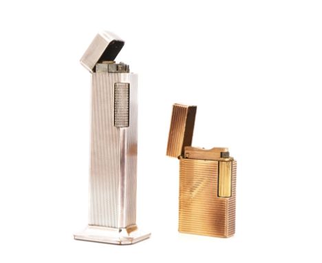 TWO GAS LIGHTERS (2)Comprising; a Dunhill Tallboy, silver plated table lighter, with engine turned decoration, height 11cm, w