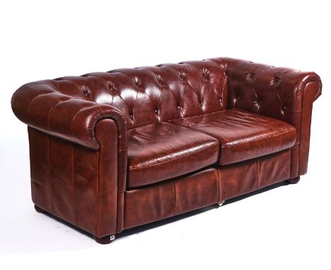 A 20TH CENTURY BROWN LEATHER UPHOLSTERED CHESTERFIELD SOFAOn bun feet, 85cm wide; 70cm high