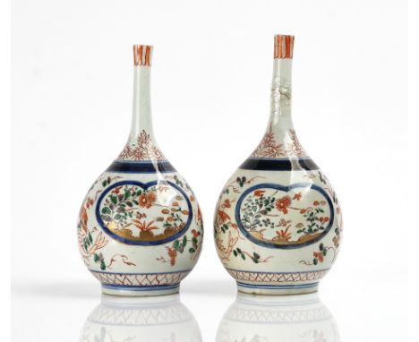 A PAIR OF JAPANESE IMARI BOTTLE VASESEdo period, early 18th centuryEach painted with flower panels against a white ground inh