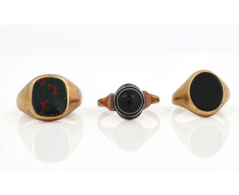 THREE RINGS (3)Comprising; a 9ct gold and oval black onyx signet ring,  ring size K and a half, a 9ct gold and bloodstone sig