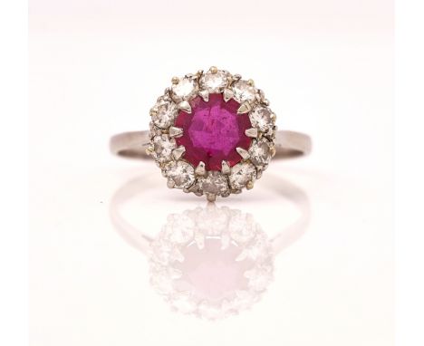 A PLATINUM, RUBY AND DIAMOND CLUSTER RINGClaw set with the circular cut ruby in a surround of ten circular cut diamonds, deta