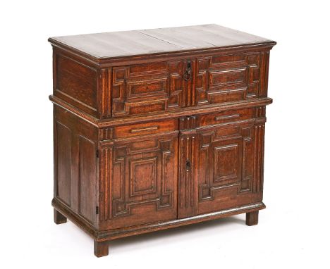 A CHARLES II JOINED OAK ENCLOSED CHEST OF DRAWERSCirca 1670, with raised geometric moulding, 105cm wide; 103cm highCondition 